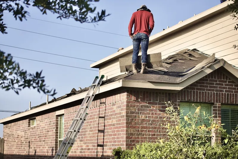 Professional roofer working on a residential roof in Sagamore Highlands